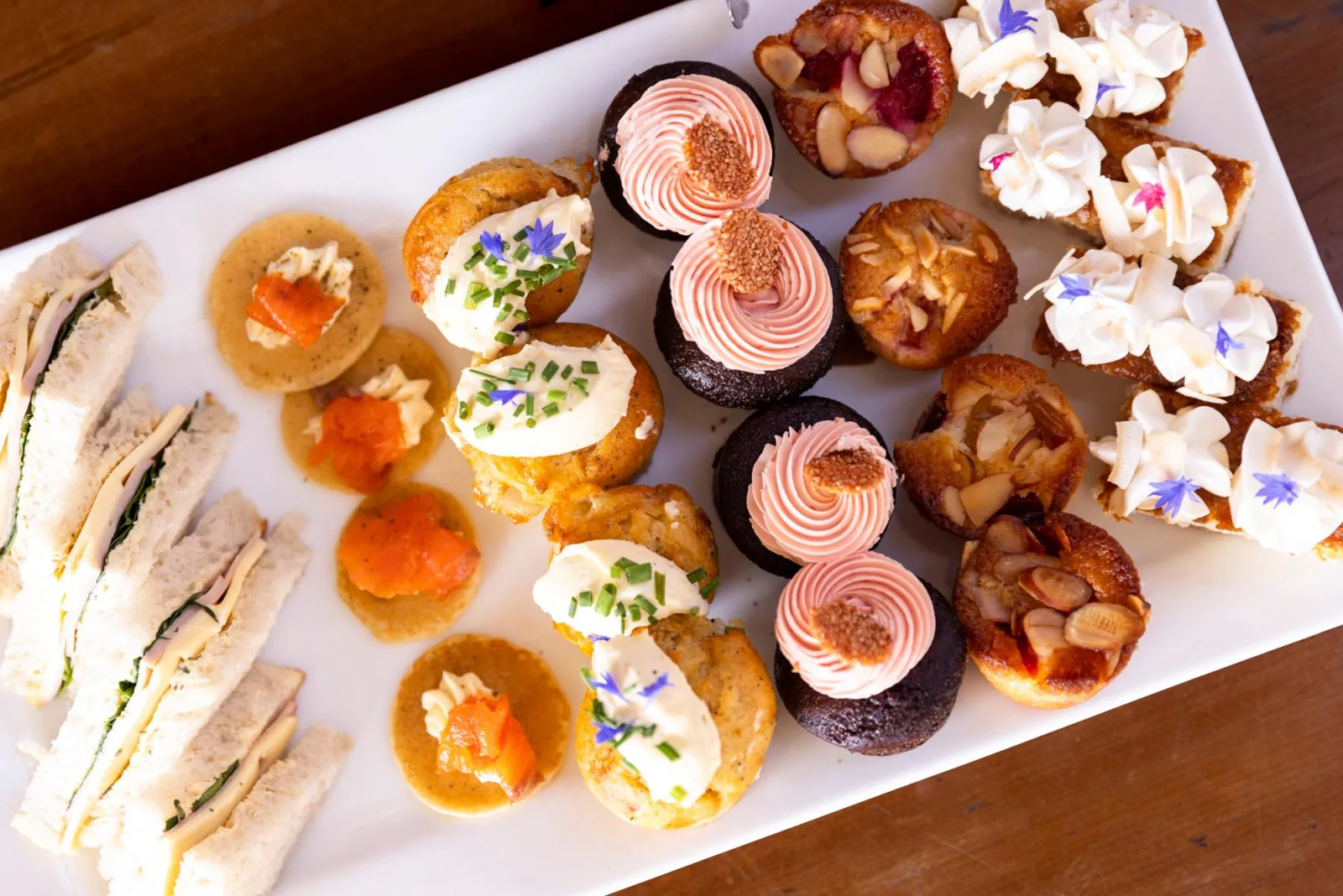 A tray of afternoon-tea savouries, cupcakes and small tarts served at Walter Peak