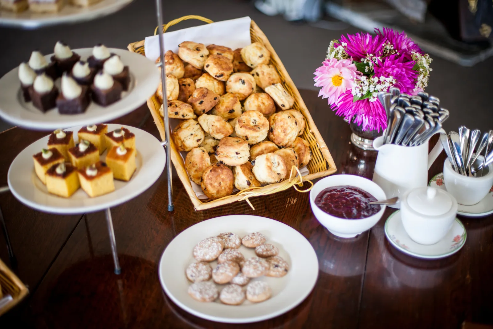 Scones, slices and preserves laid out with flowers for morning tea in the woolshed