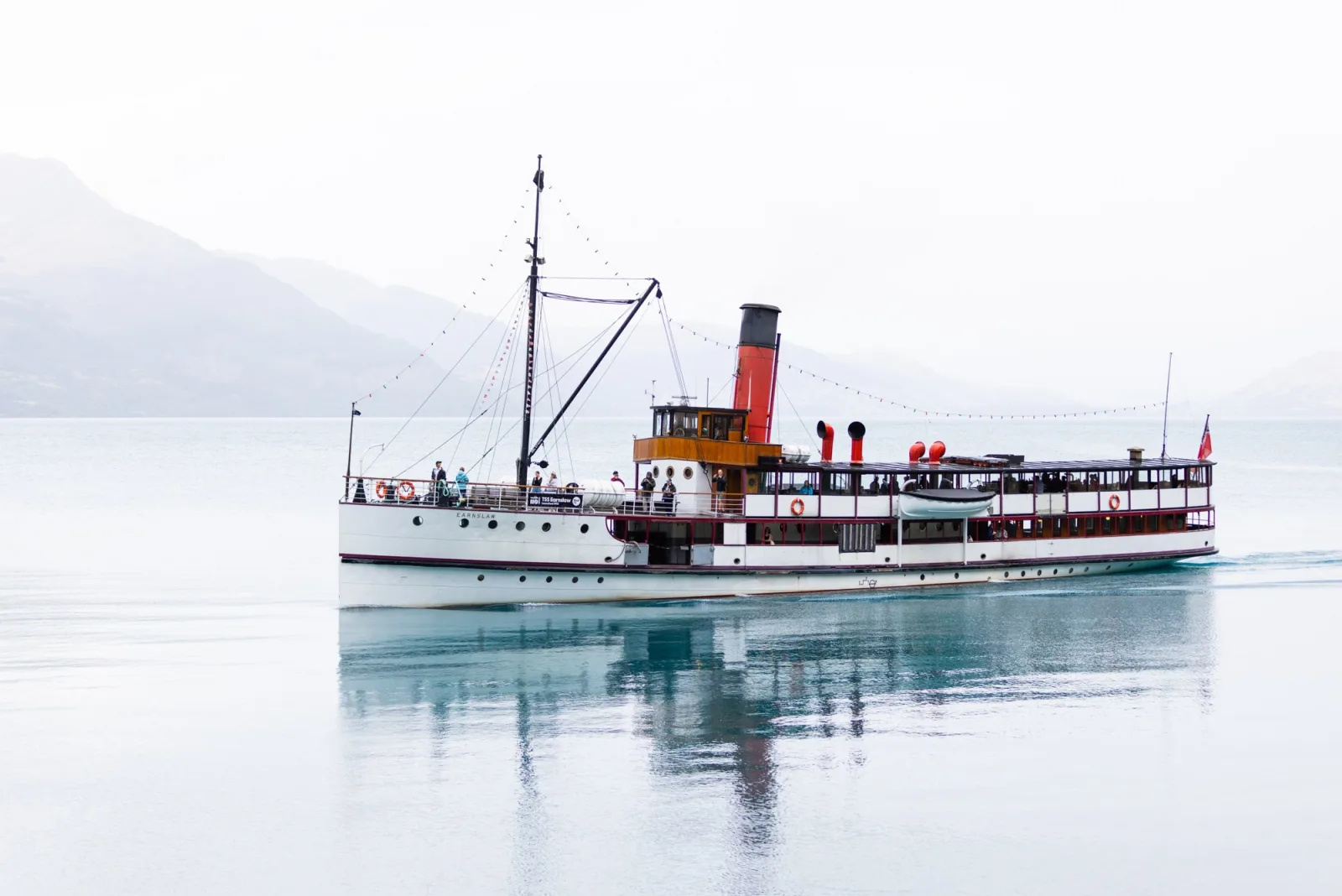 The TSS Earnslaw crossing a glassy Lake Whakatipu on a calm morning