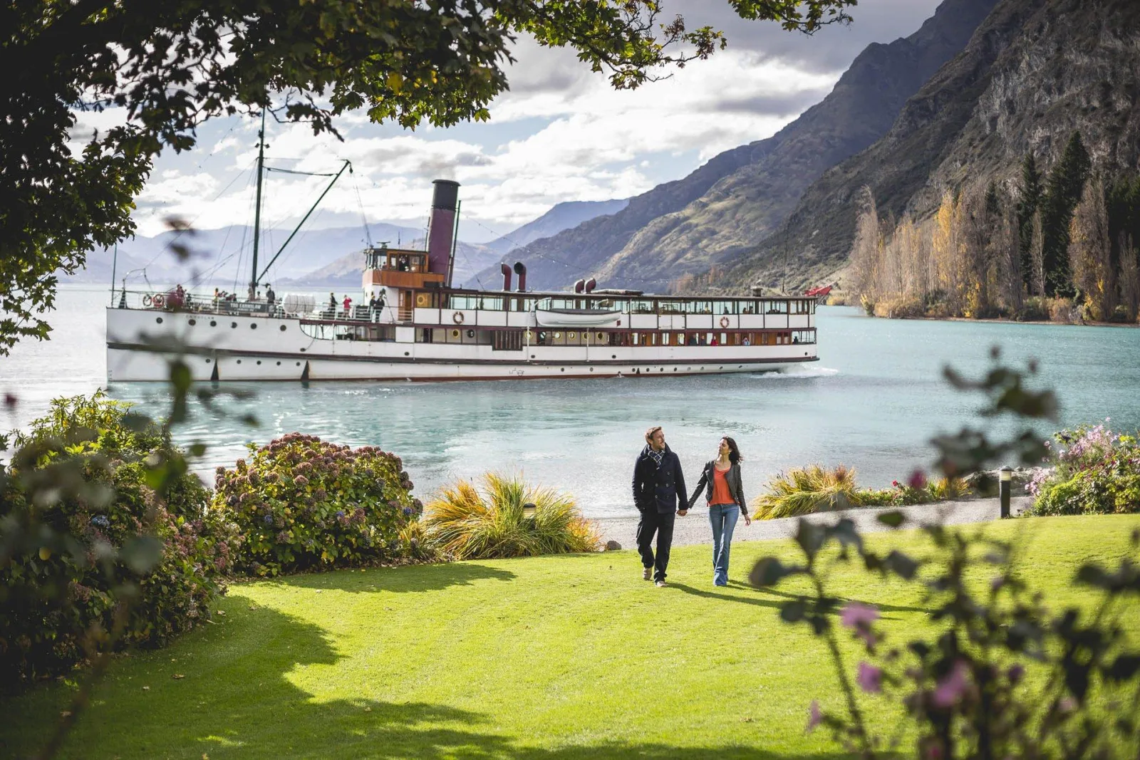 The TSS Earnslaw berthed below the Walter Peak lawn, seen through the homestead garden
