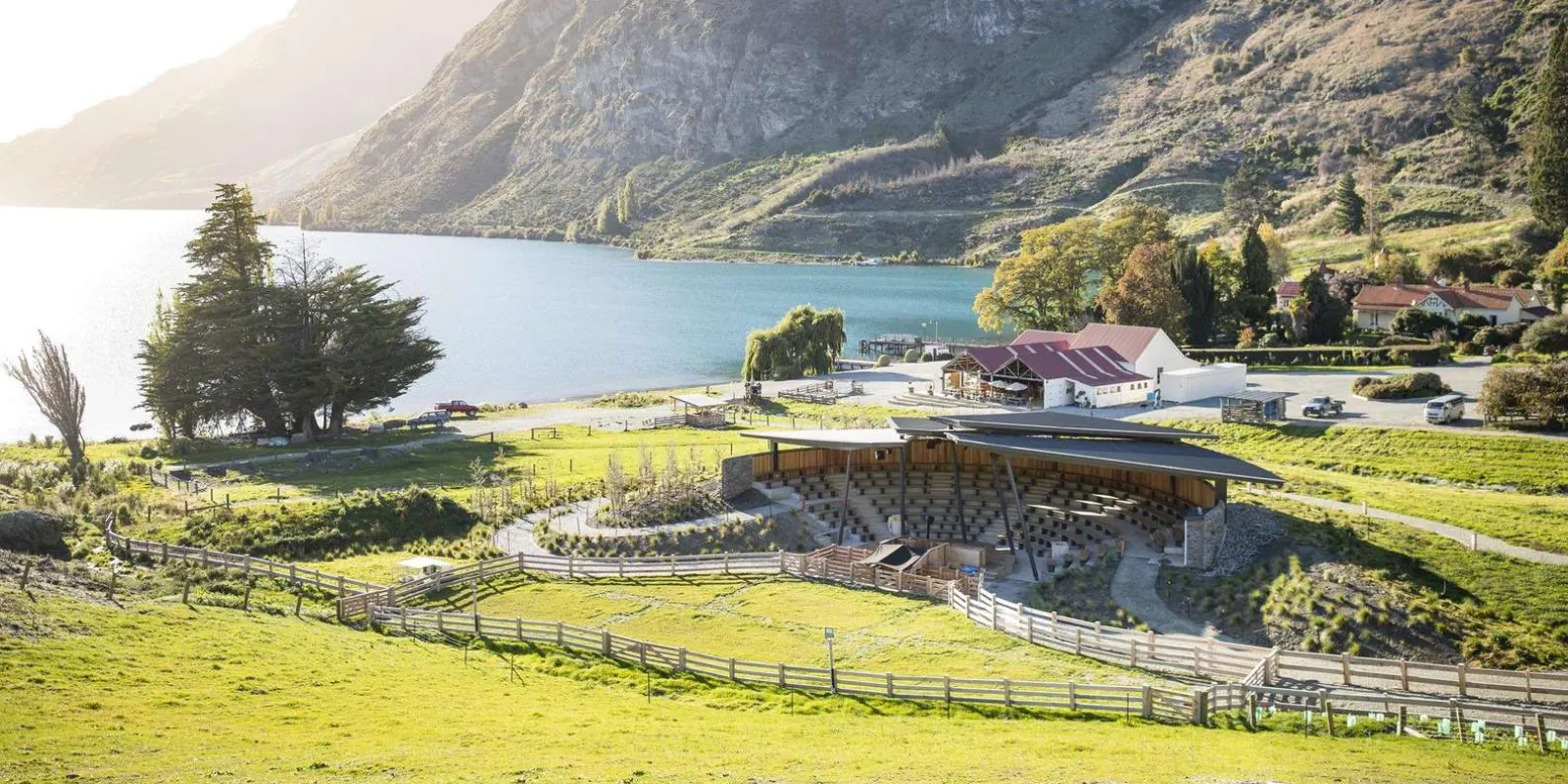 Walter Peak Station from the hillside above — the amphitheatre, the paddocks and the homestead running down to the lake